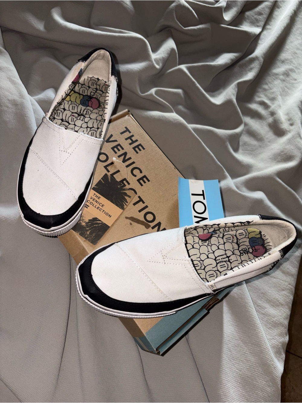 TOMS White Canvas Slip-On Shoes with Black Trim